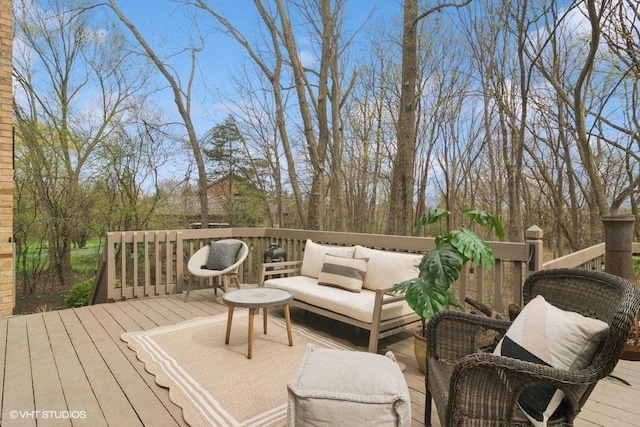 wooden terrace with an outdoor living space