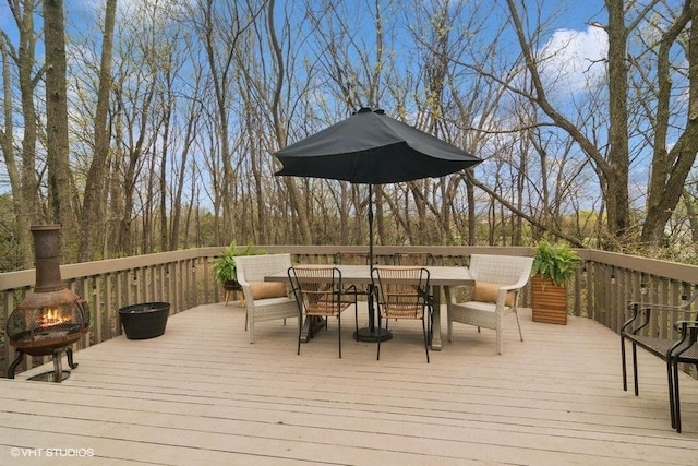 deck with an outdoor fire pit and outdoor dining space