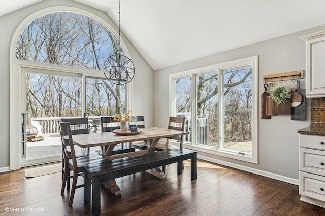dining space featuring baseboards, dark wood finished floors, and high vaulted ceiling