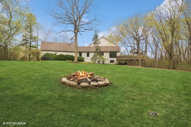 view of yard with a fire pit