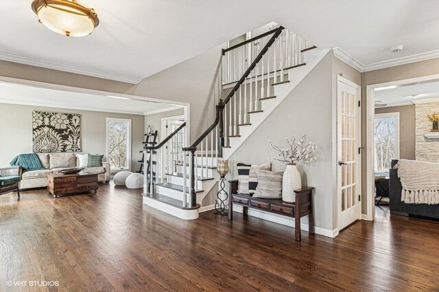 interior space featuring crown molding, wood finished floors, and stairway
