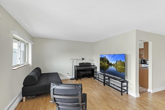 680 Marilyn Ave Unit 201, Glendale Heights, IL 60139 - living room with baseboard heating, light wood finished floors, and baseboards