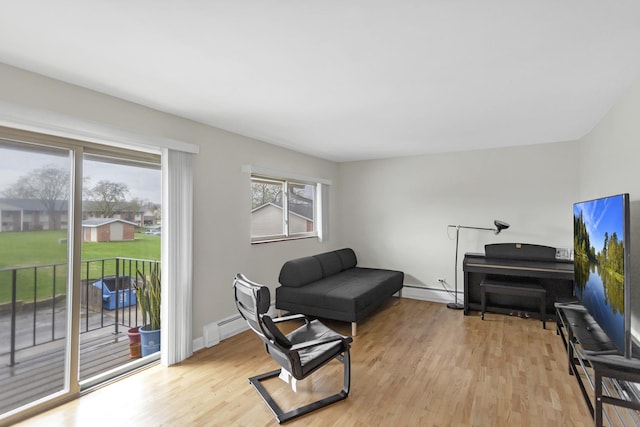 680 Marilyn Ave Unit 201, Glendale Heights, IL 60139 - sitting room featuring light wood finished floors, a baseboard heating unit, a baseboard radiator, and baseboards