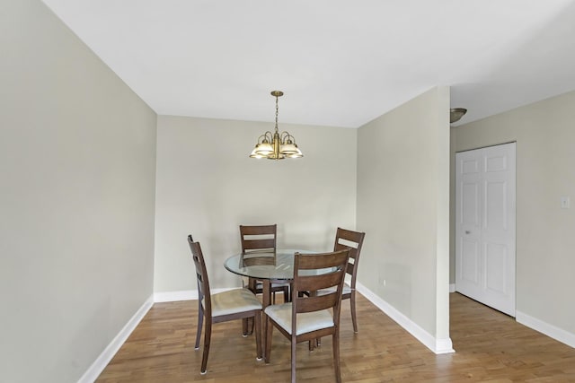 680 Marilyn Ave Unit 201, Glendale Heights, IL 60139 - dining room featuring light wood finished floors, a chandelier, and baseboards