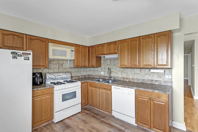 680 Marilyn Ave Unit 201, Glendale Heights, IL 60139 - kitchen featuring white appliances, a sink, decorative backsplash, and wood finished floors