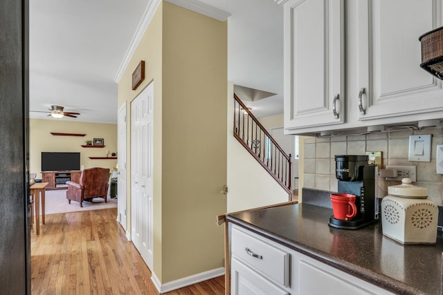 7817 Cascade Way, Gurnee, IL 60031 - kitchen featuring backsplash, a ceiling fan, light wood-style flooring, white cabinetry, and crown molding