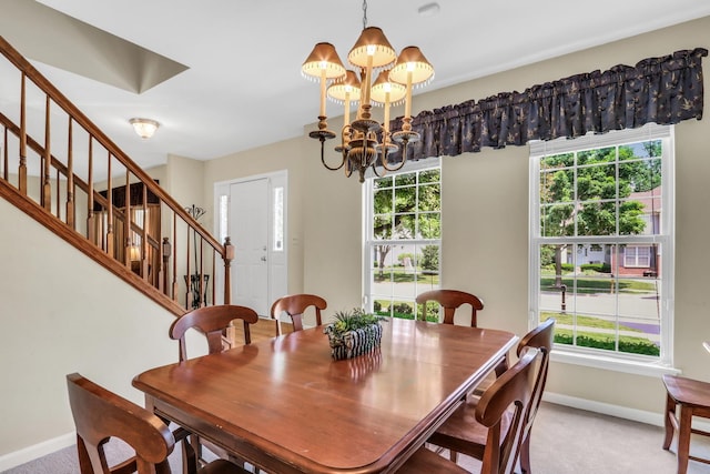7817 Cascade Way, Gurnee, IL 60031 - dining area with light colored carpet, stairway, and a chandelier