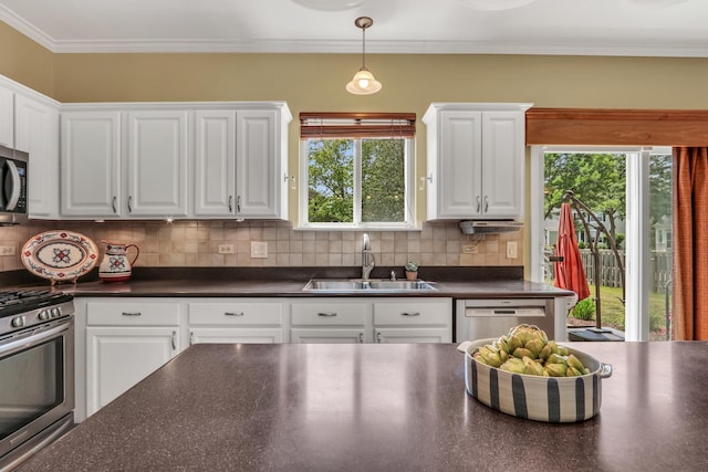 7817 Cascade Way, Gurnee, IL 60031 - kitchen with stainless steel appliances, dark countertops, white cabinets, tasteful backsplash, and crown molding