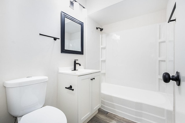 full bathroom with vanity, toilet, wood finished floors, and washtub / shower combination