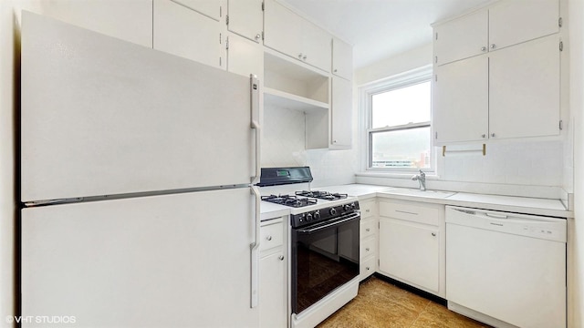 kitchen featuring a sink, white cabinetry, white appliances, light countertops, and tasteful backsplash