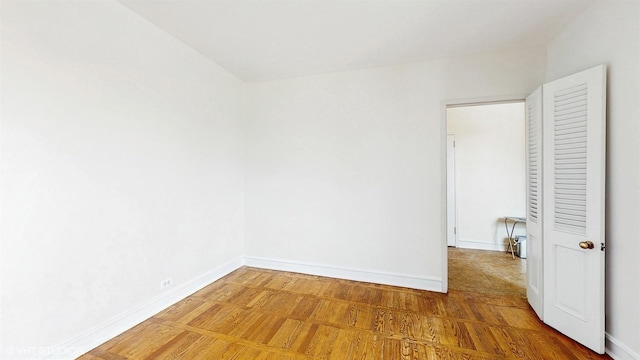 spare room with baseboards