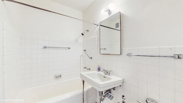 full bathroom featuring tile walls and shower / bathtub combination