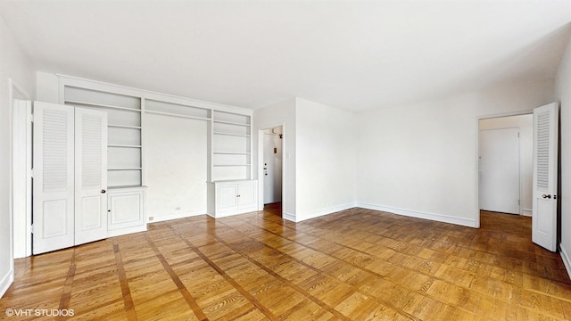 unfurnished bedroom with baseboards and a closet