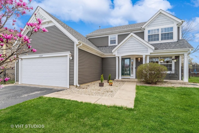 view of front of home with a front lawn, aphalt driveway, fence, a shingled roof, and an attached garage