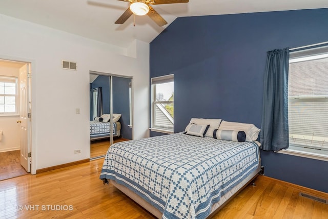 bedroom with visible vents, multiple windows, and light wood-style flooring