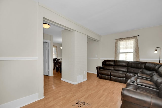 living room featuring light wood-style flooring and baseboards