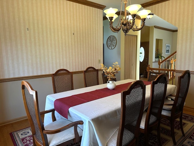 2115 Stafford Ct, Plainfield, IL 60586 - dining space featuring crown molding, wood finished floors, wallpapered walls, baseboards, and a notable chandelier