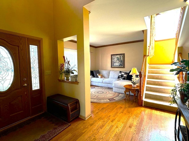 2115 Stafford Ct, Plainfield, IL 60586 - foyer entrance with ornamental molding, a healthy amount of sunlight, stairs, and light wood finished floors