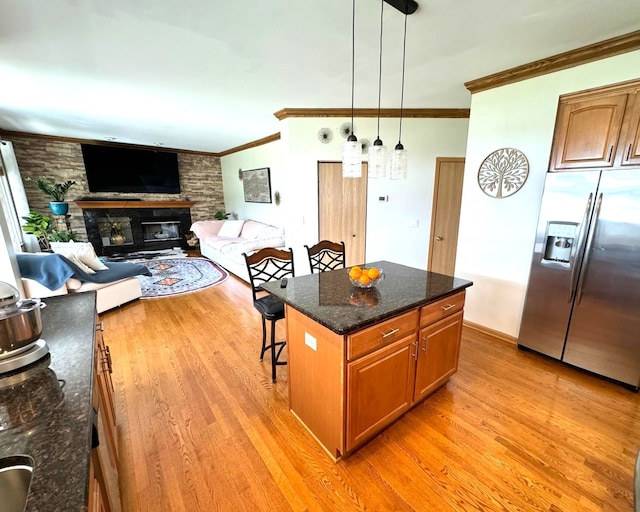 2115 Stafford Ct, Plainfield, IL 60586 - kitchen with a breakfast bar, stainless steel fridge, light wood-style floors, and ornamental molding