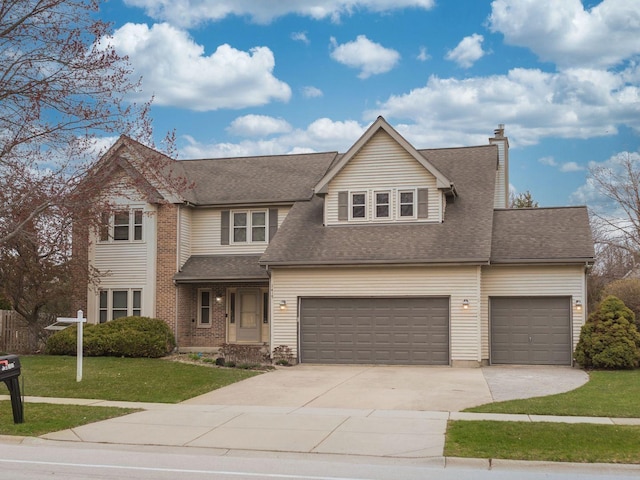 traditional-style house with a chimney, concrete driveway, an attached garage, a shingled roof, and a front yard