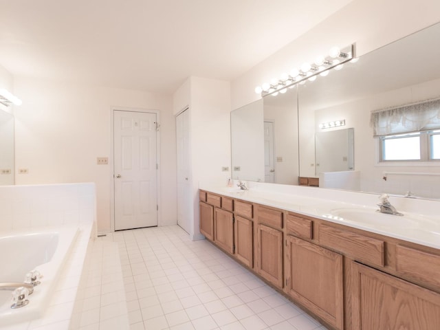 full bath featuring a garden tub, tile patterned floors, a sink, and double vanity