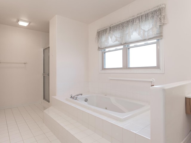 bathroom with a shower stall, a jetted tub, and tile patterned flooring
