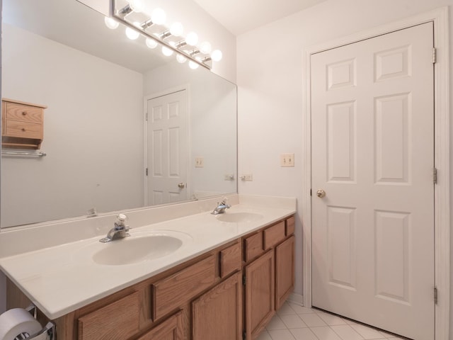 bathroom featuring tile patterned flooring, a sink, and double vanity