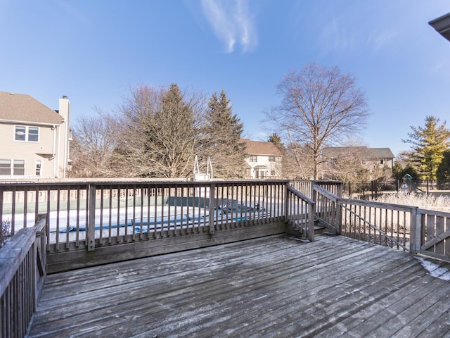 wooden terrace with a residential view and a fenced in pool