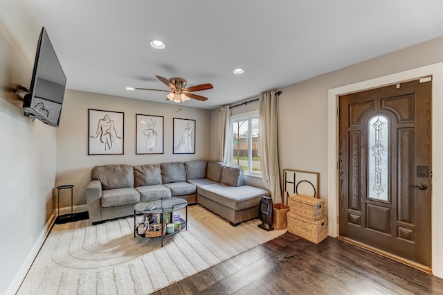 living room with baseboards, wood finished floors, a ceiling fan, and recessed lighting