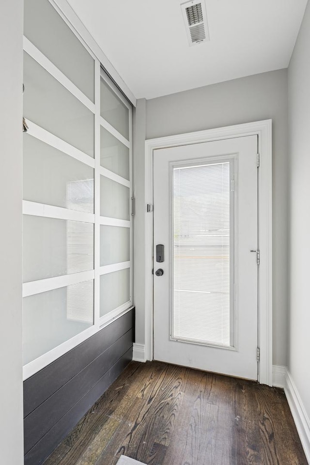 4825 W Ainslie St, Chicago, IL 60630 - doorway to outside featuring dark wood-style flooring