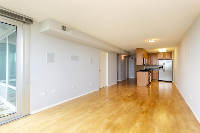 9715 Woods Dr Unit 805, Skokie, IL 60077 - kitchen with appliances with stainless steel finishes, brown cabinets, dark countertops, light wood finished floors, and open floor plan