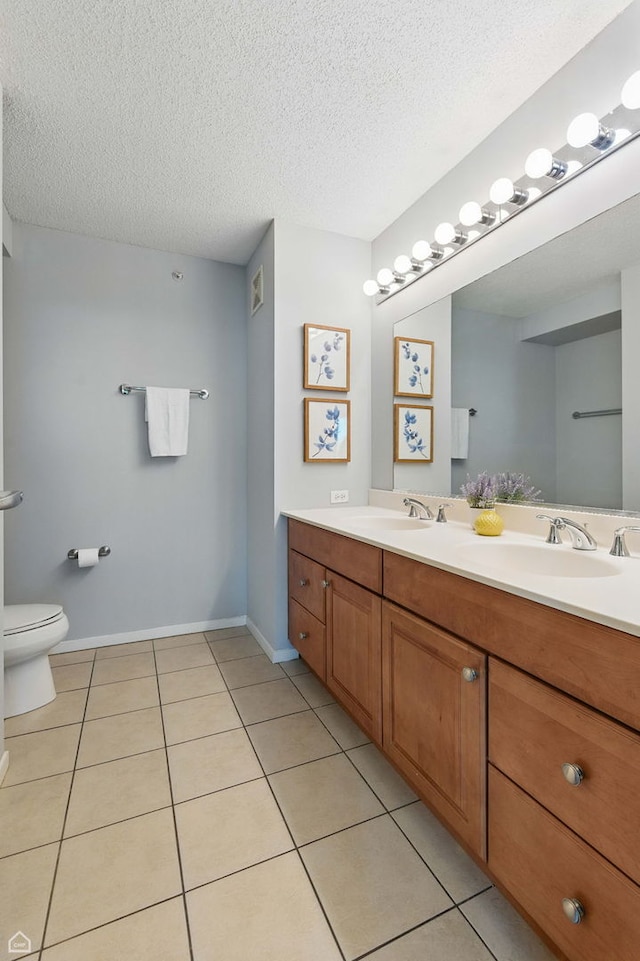 9715 Woods Dr Unit 805, Skokie, IL 60077 - bathroom featuring double vanity, tile patterned floors, and a textured ceiling