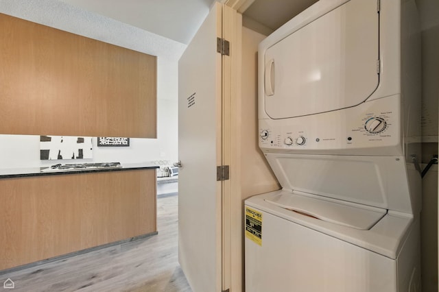 9715 Woods Dr Unit 805, Skokie, IL 60077 - laundry room with estacked washer and dryer and light wood finished floors