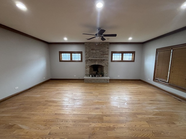 unfurnished living room featuring a healthy amount of sunlight, crown molding, baseboards, and ceiling fan