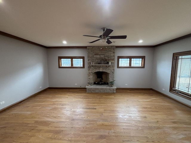 unfurnished living room with baseboards, ornamental molding, and a healthy amount of sunlight