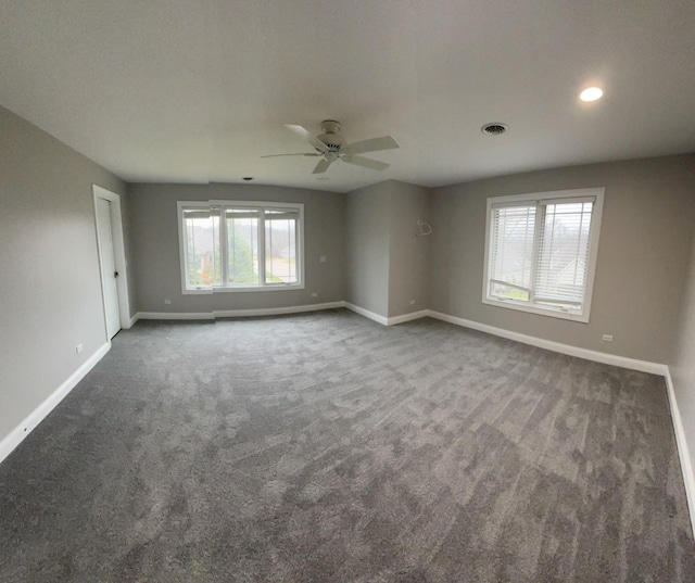 carpeted empty room with visible vents, baseboards, recessed lighting, and ceiling fan