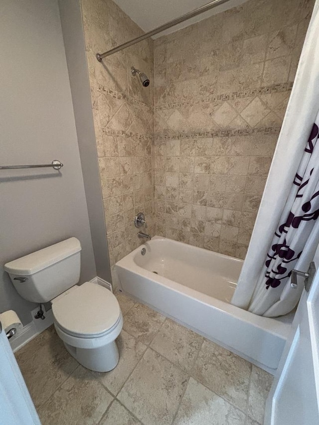 bathroom featuring shower / tub combo and toilet
