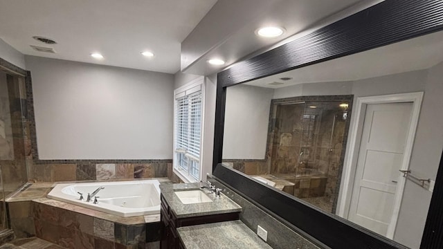 bathroom featuring a bath, vanity, recessed lighting, and a shower stall