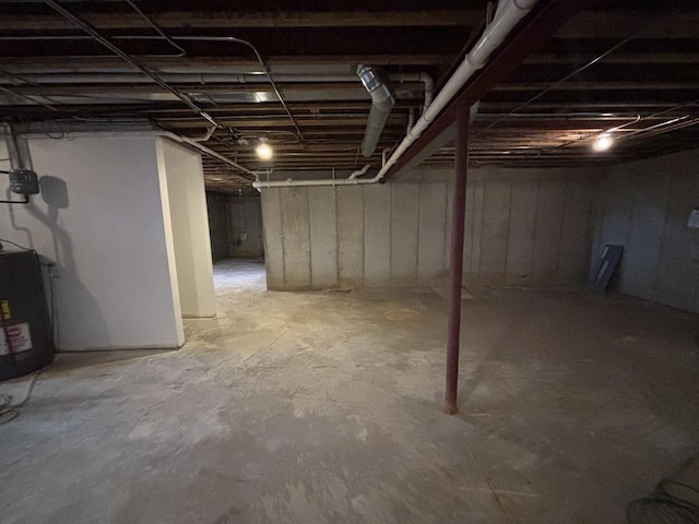 unfinished below grade area featuring water heater