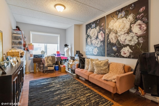 living area with a textured ceiling and wood finished floors