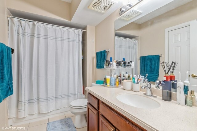 bathroom with visible vents, tile patterned flooring, toilet, and vanity