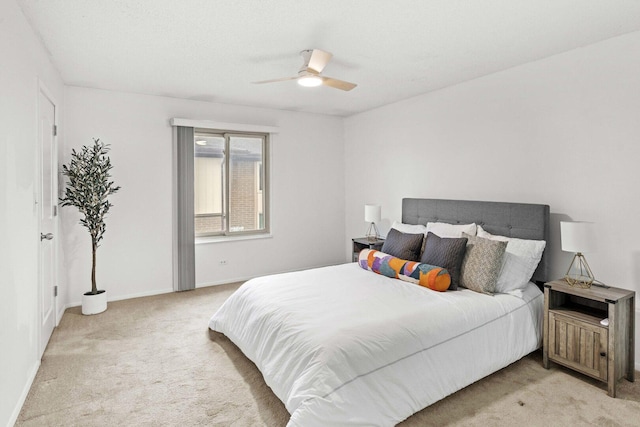 carpeted bedroom with a ceiling fan and baseboards
