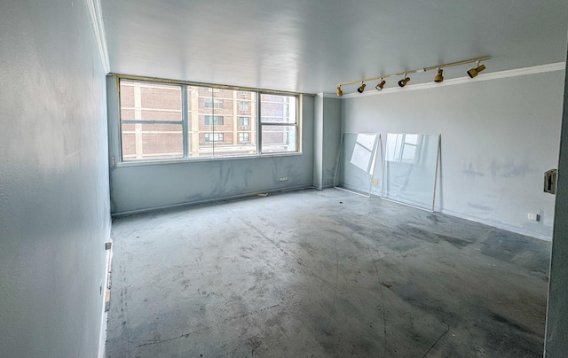 6301 N Sheridan Rd Unit 6D, Chicago, IL 60660 - empty room featuring ornamental molding, track lighting, and unfinished concrete floors
