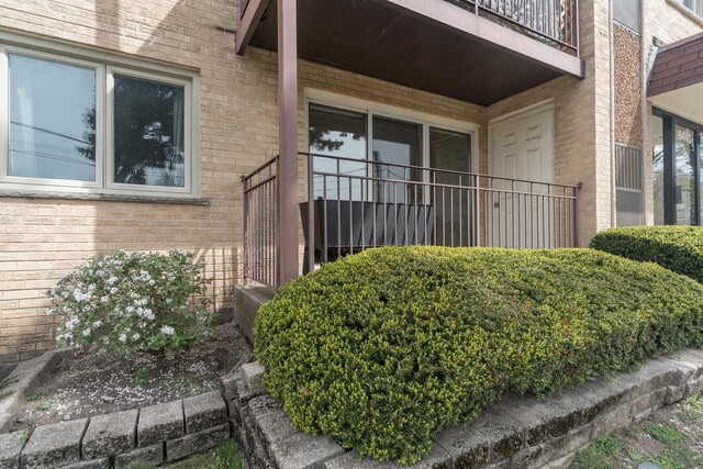 doorway to property with brick siding