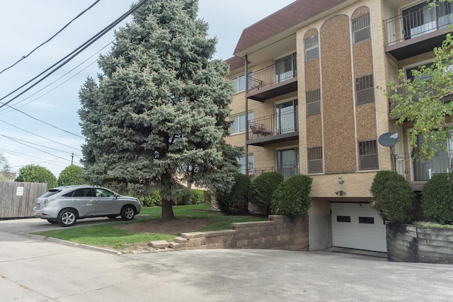 view of property featuring an attached garage and concrete driveway
