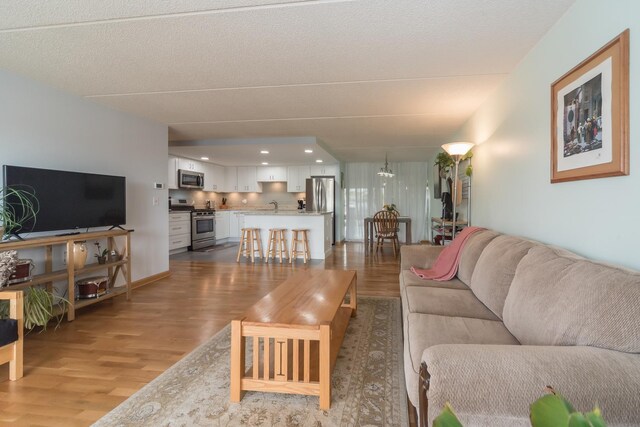 living room featuring recessed lighting and wood finished floors