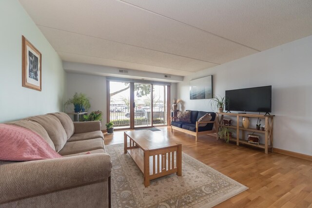 living room with light wood-type flooring and visible vents