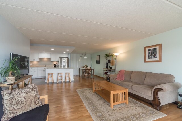 living room with recessed lighting and light wood-style floors