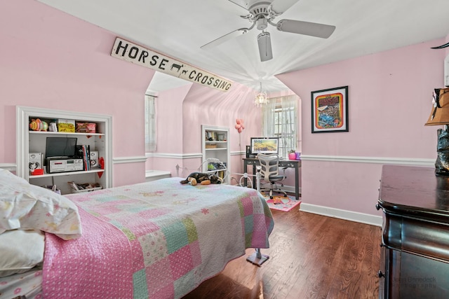bedroom featuring ceiling fan with notable chandelier, wood finished floors, and baseboards