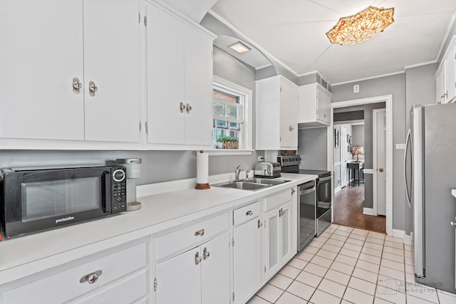 kitchen featuring a sink, white cabinetry, stainless steel appliances, and light countertops